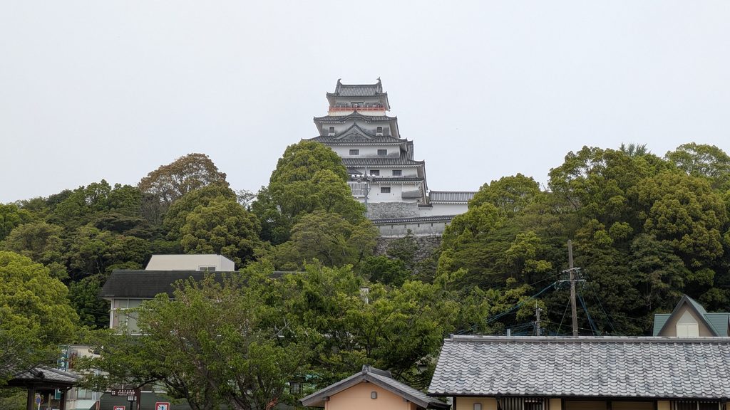 樹木に覆われた丘の上に建つ唐津城の模擬天守